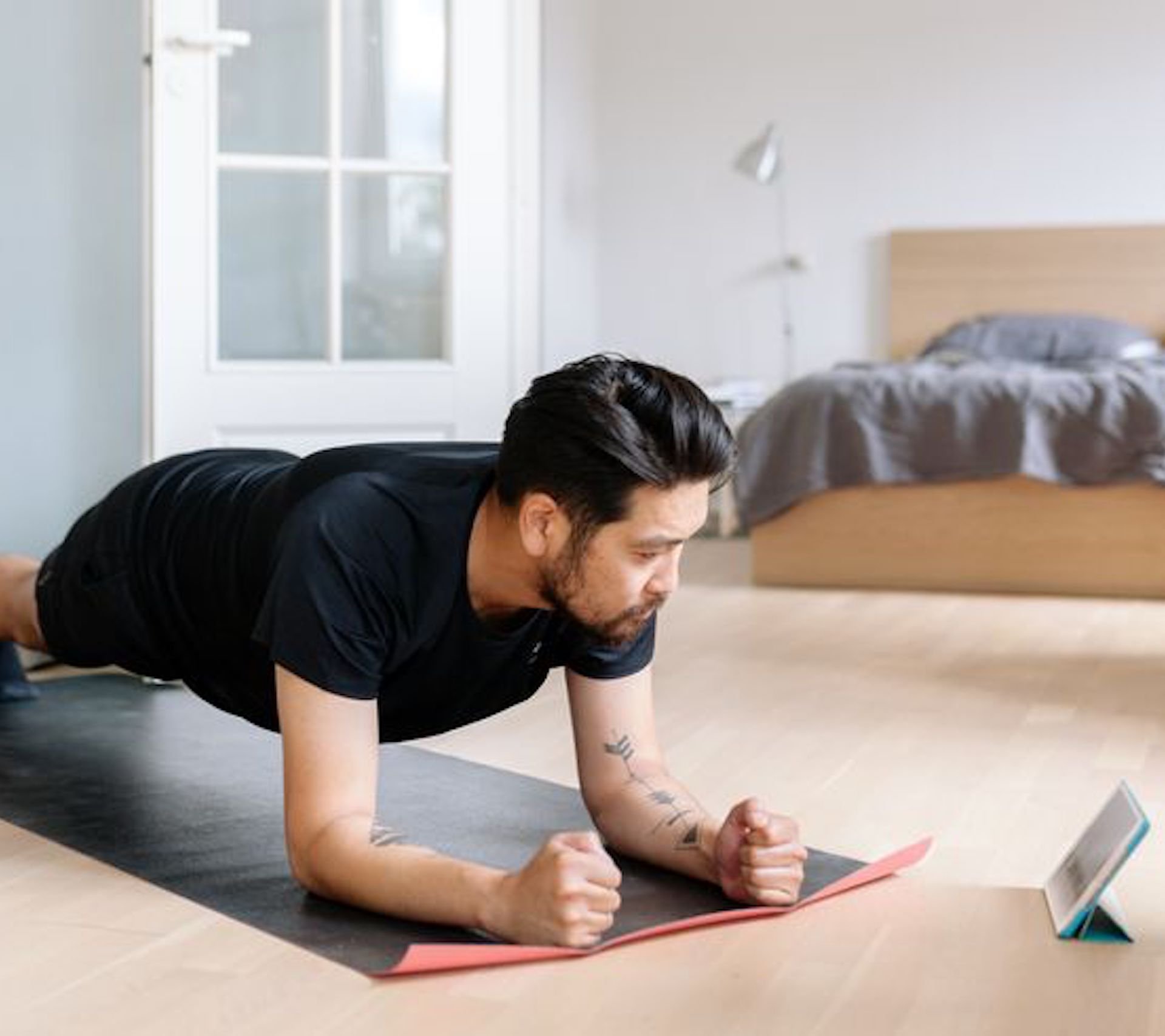 asian-man-uses-digital-tablet-to-lean-plank-royalty-free-image-1584377468